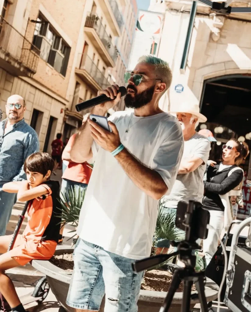 Speaker en evento de calle o activación exterior, animando a la multitud.